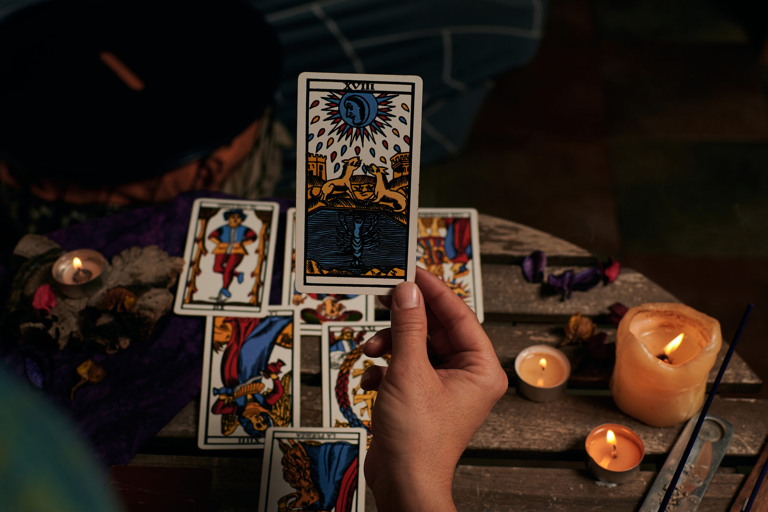 Close-up of a fortune teller reading tarot cards